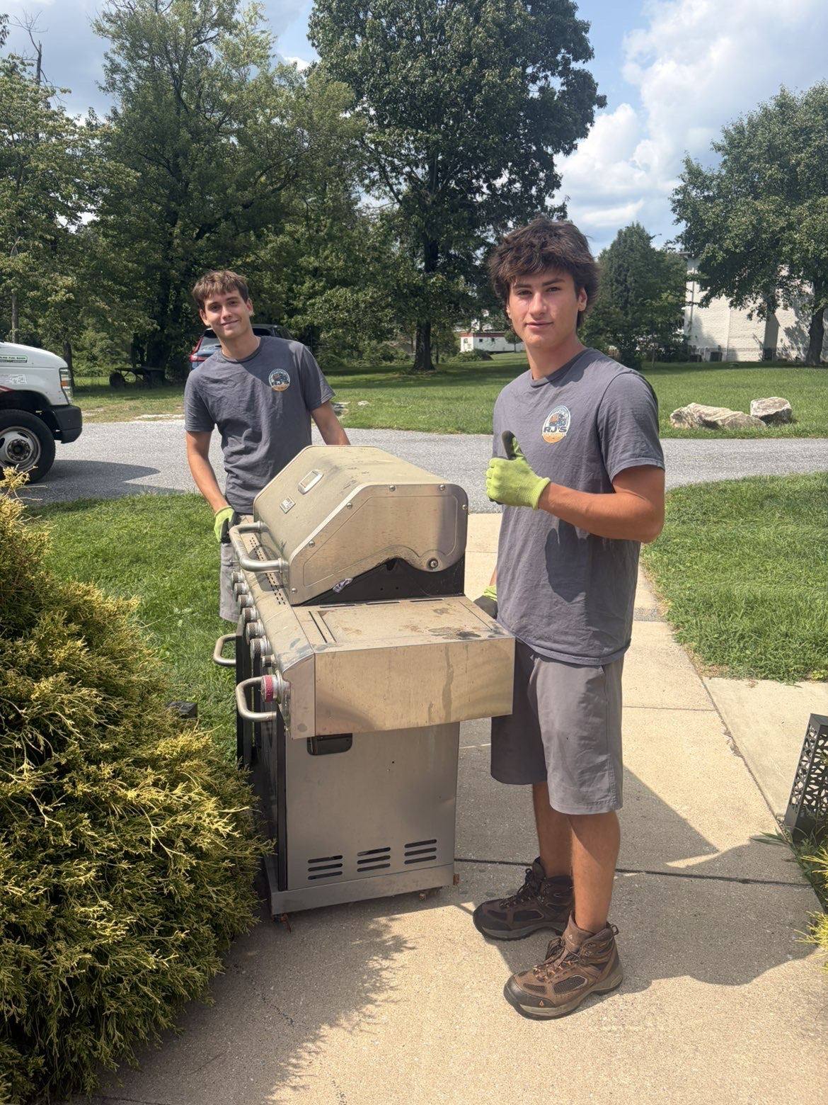 RJ's crew hauling away an old gas grill