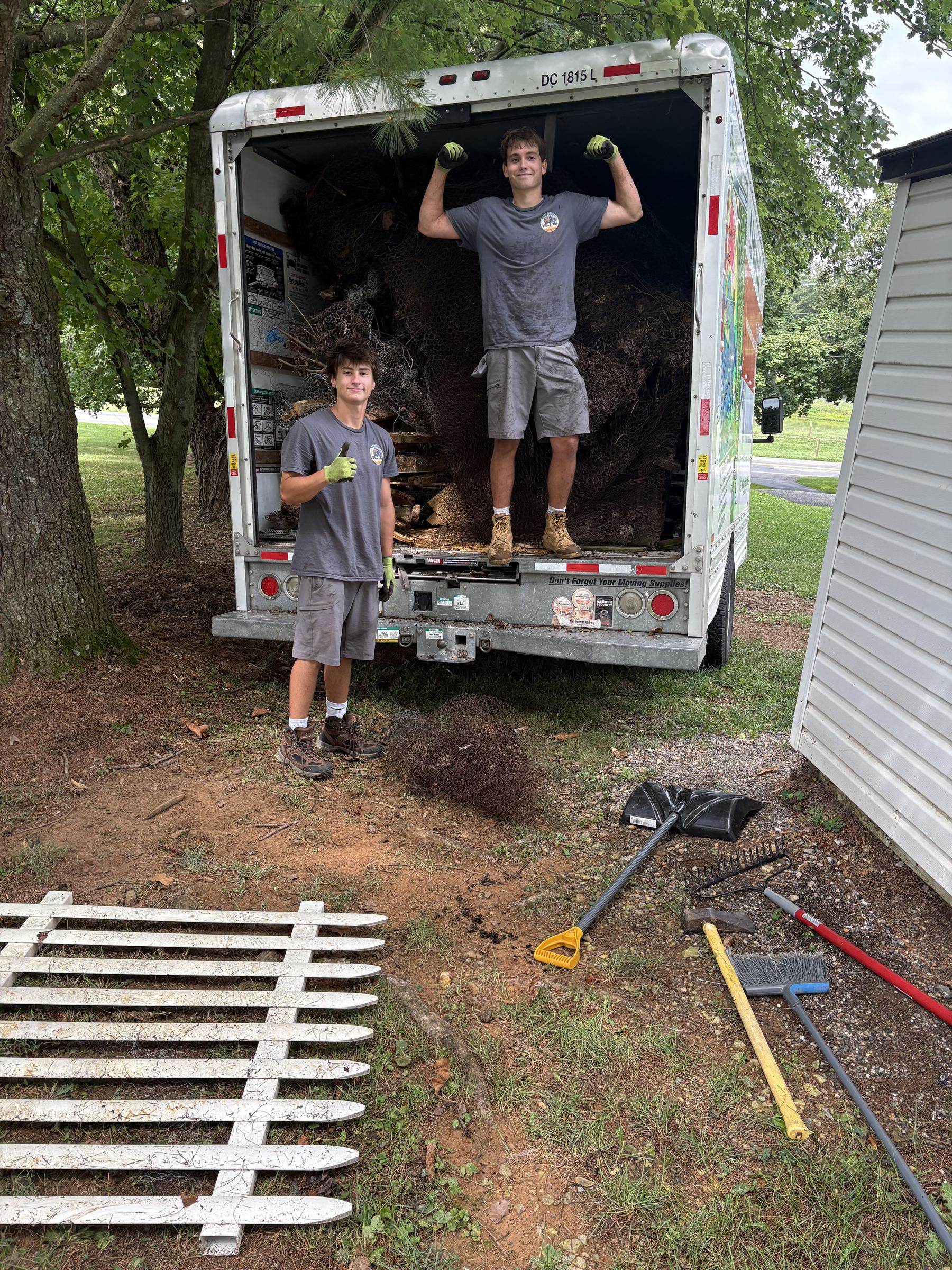 RJ's crew loading yard debris and an old fence into the truck